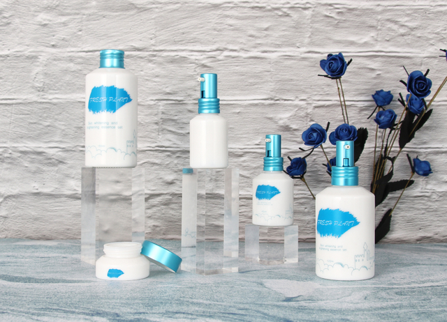 White Glass Bottles And Jars with Blue Lids